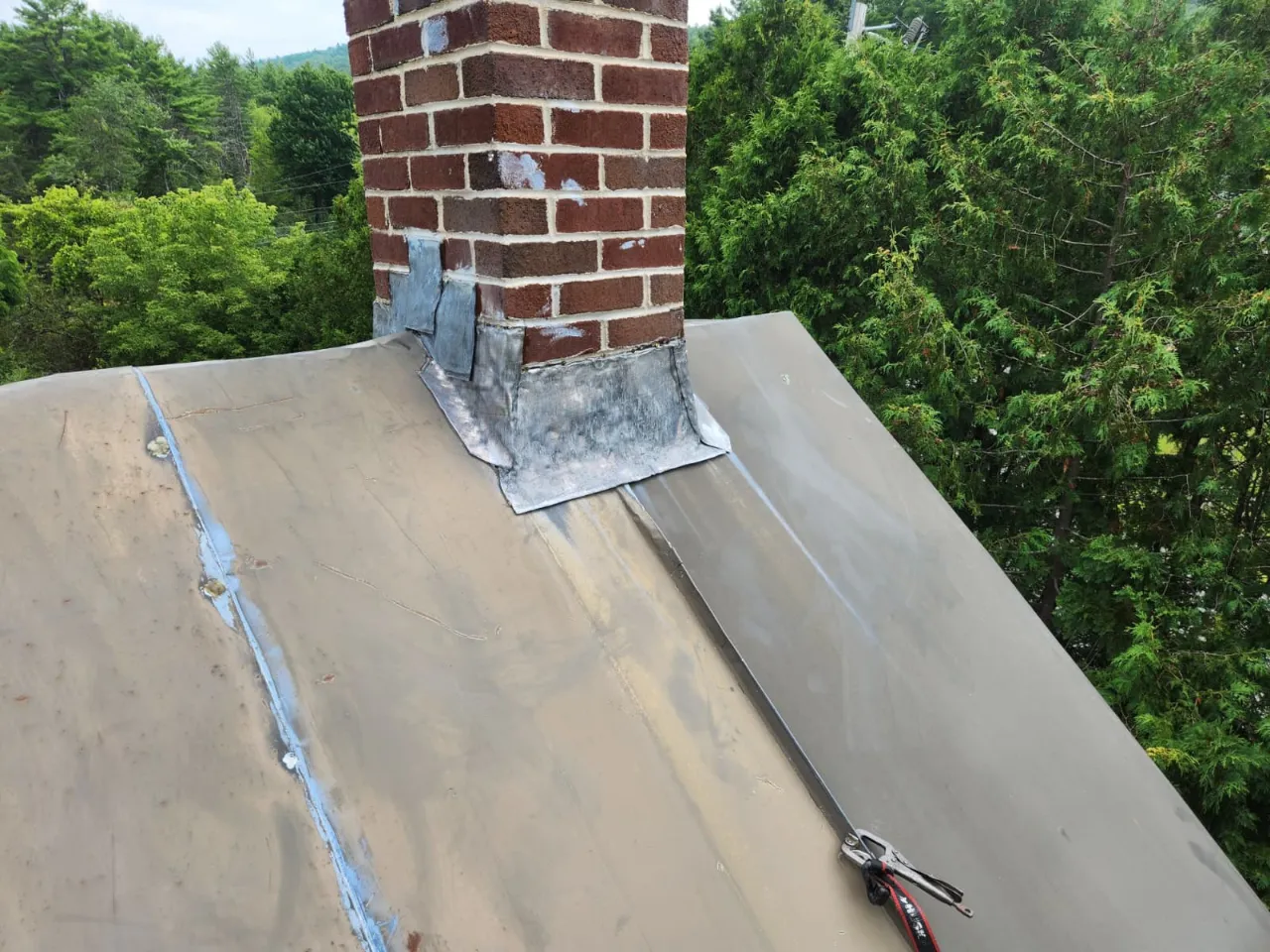 Roofing crew working on a residential roof in Vermont